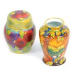 A Moorcroft Pottery miniature enamel ginger jar and cover decorated in the Pomegranate