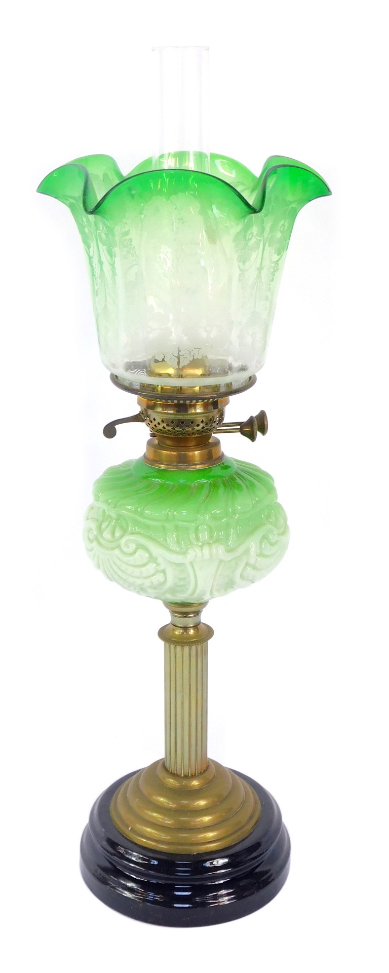 A 19thC brass and green opaline glass oil lamp, on a black socle base, with stepped brass foot on a