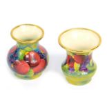 A Moorcroft Pottery miniature enamel Pomegranate pattern vase, 4.5cm high, and a further