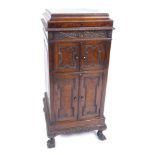 An early 20thC oak cased cabinet gramophone, with record played inset top, and two swing doors with