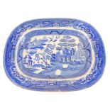 A late 19thC Willow pattern blue and white pottery meat platter, 47cm wide. (AF)