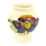 A Moorcroft Columbine pattern vase, impressed and painted marks, on a cream ground, with red and yel