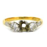 An 18ct and platinum diamond three stone dress ring, set in platinum with claw setting on a yellow m