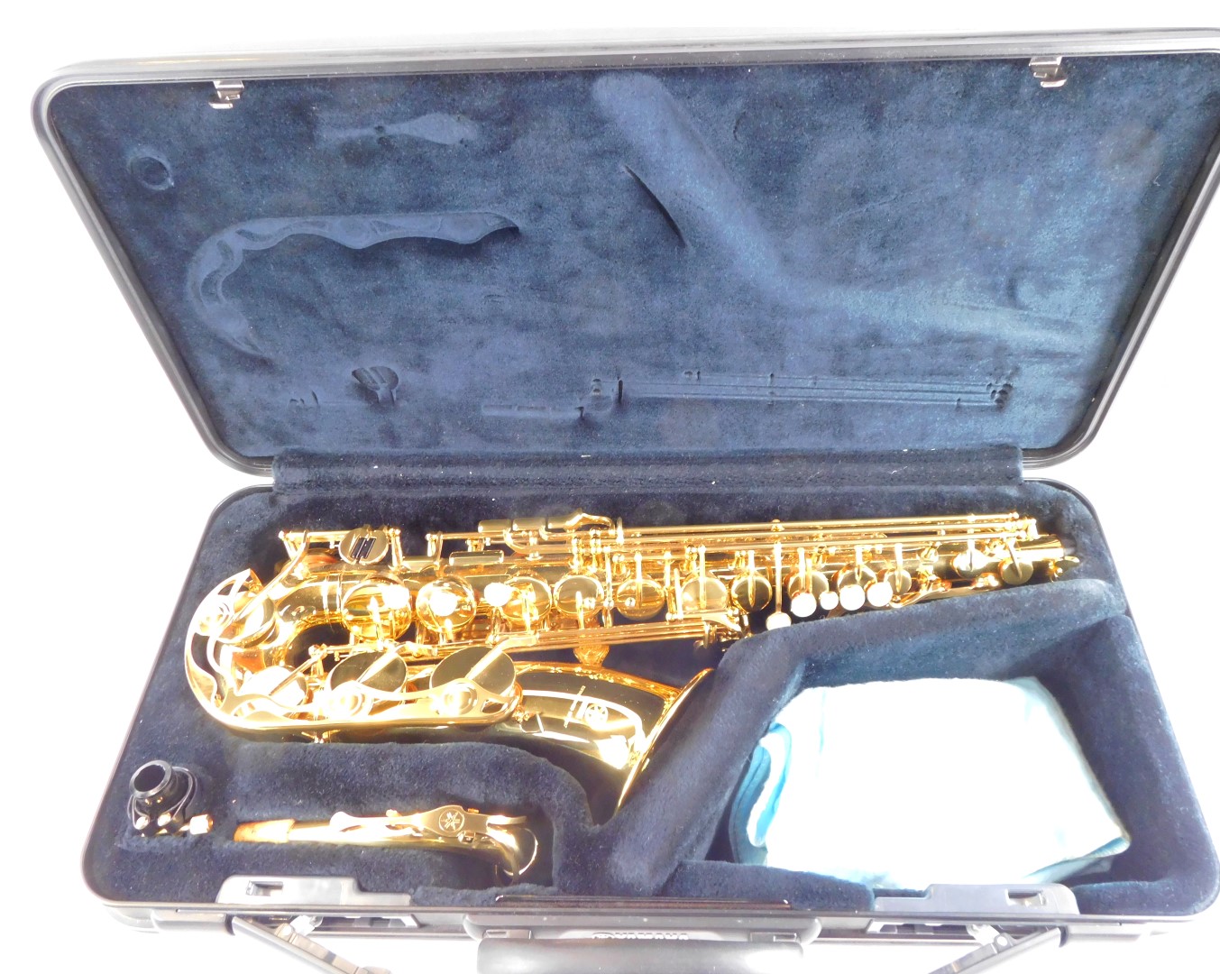 A Yamaha brass saxophone, Yas-275, number 257424, cased, together with stands, music books and clean