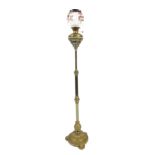 A Victorian brass adjustable standard lamp, with opaque white shade, and beaded dress, on adjustable