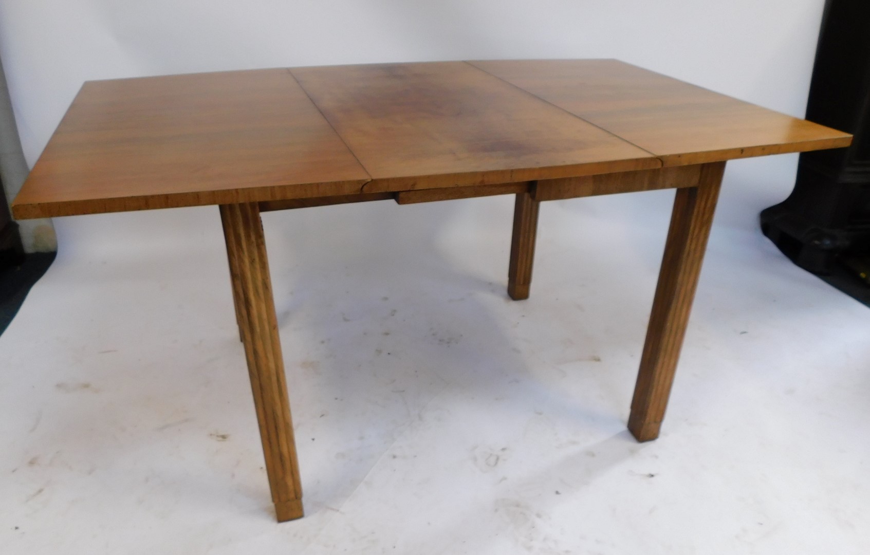 A mid century walnut drop leaf table, with quarter veneered top, on reeded column legs, 76cm high, 9 - Image 2 of 3