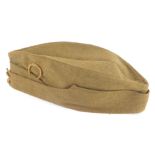 A WWII Army side cap, with Rutland Horseshoe badge, dated 1941, 30cm wide.