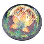 A Moorcroft Pottery dish decorated with flowers, circa 2002, painted and impressed marks, 11.5cm wid