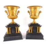 A pair of late 19thC gilt brass and slate garniture vases, the vases of semi fluted campana form, em