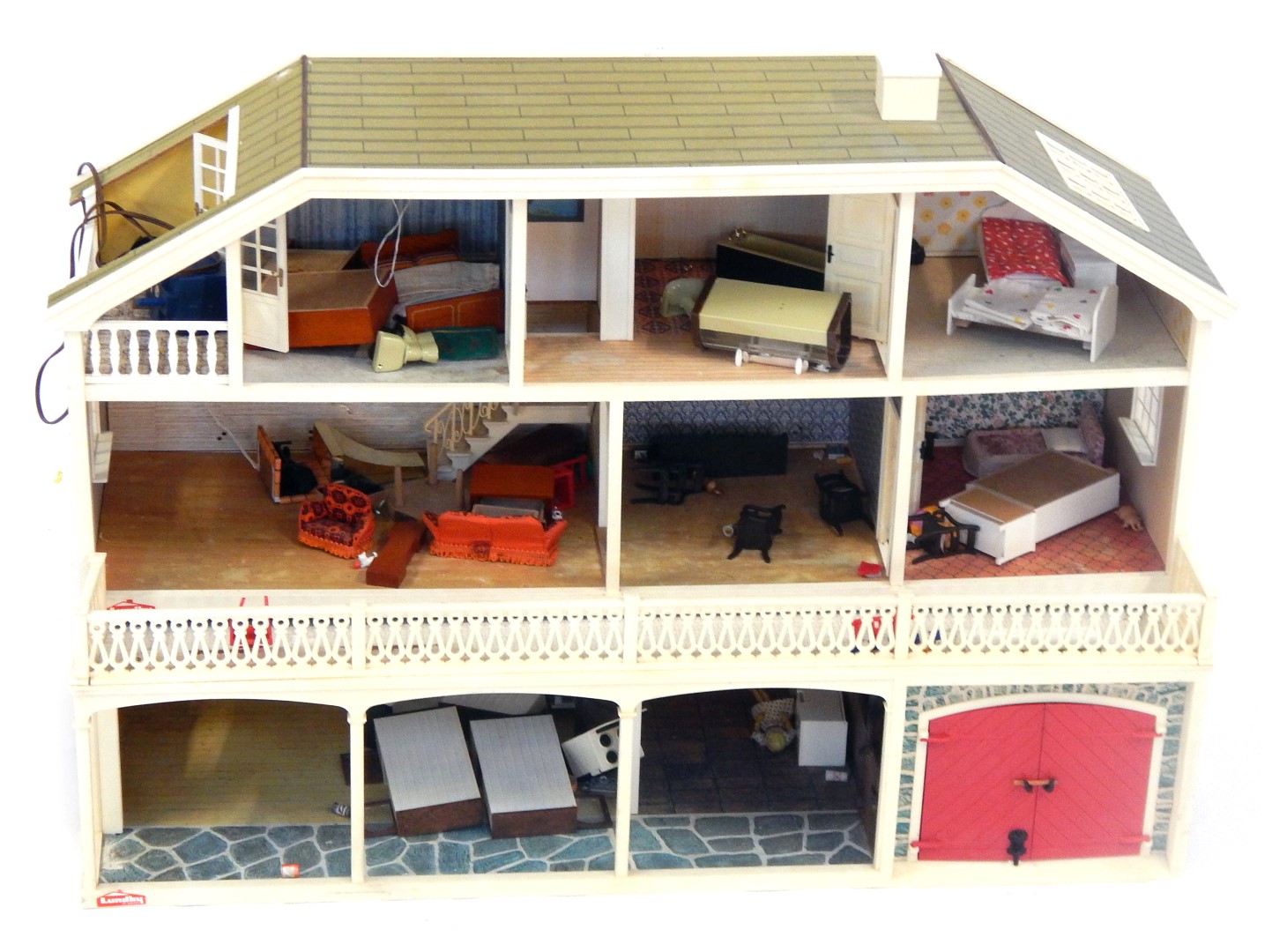 A Lundby doll's house, the house with a tiled roof, and glazed window panels with balcony and lower