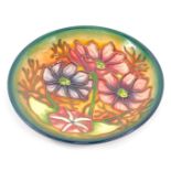 A Moorcroft Pottery dish decorated with flowers, circa 2000, painted and impressed marks, 11.5cm wid