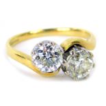 An 18ct gold diamond two stone twist ring, set with two bold cut diamonds, each stone approx 0.87ct,