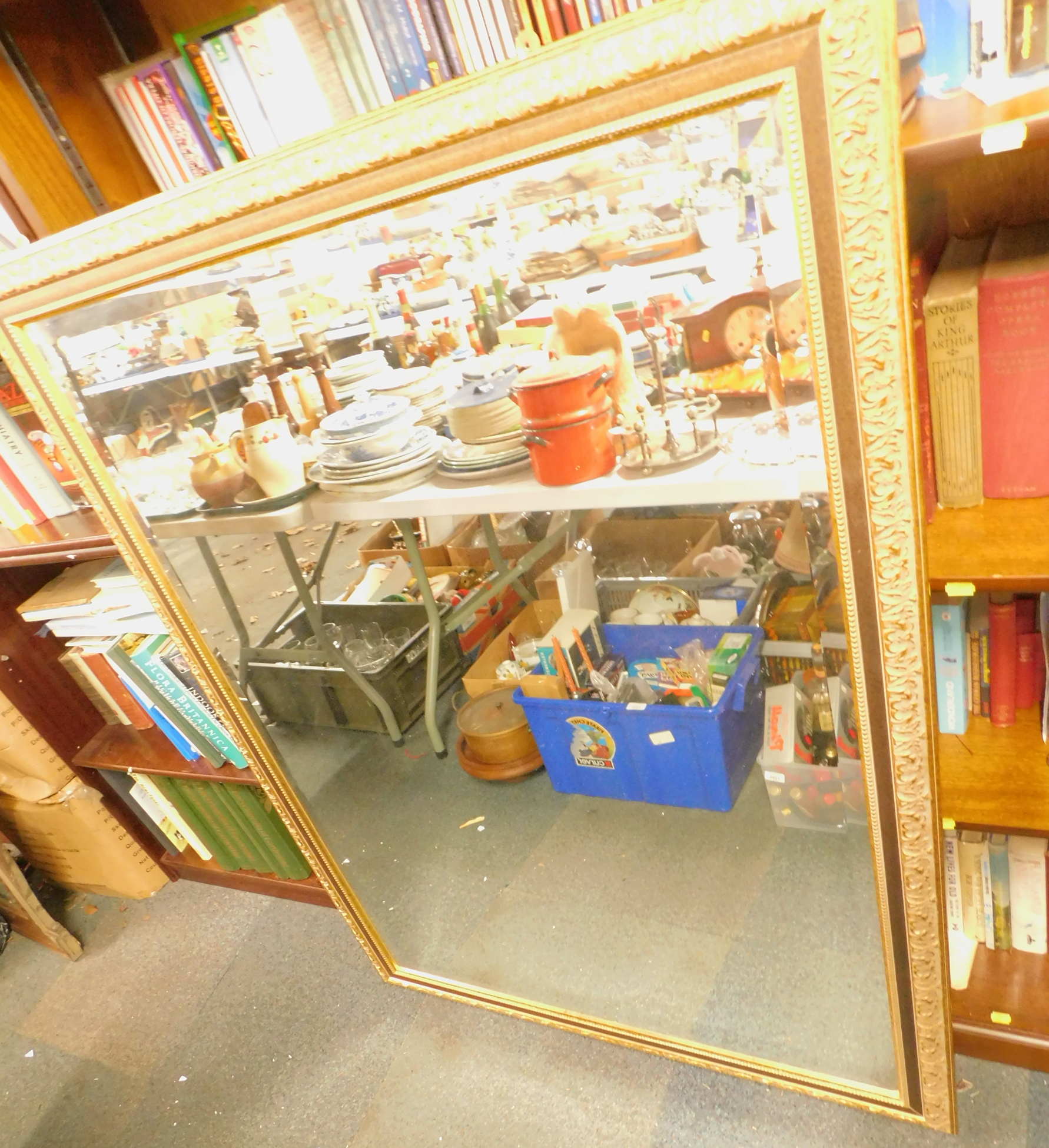 A large gilt framed rectangular wall mirror, with a floral border.