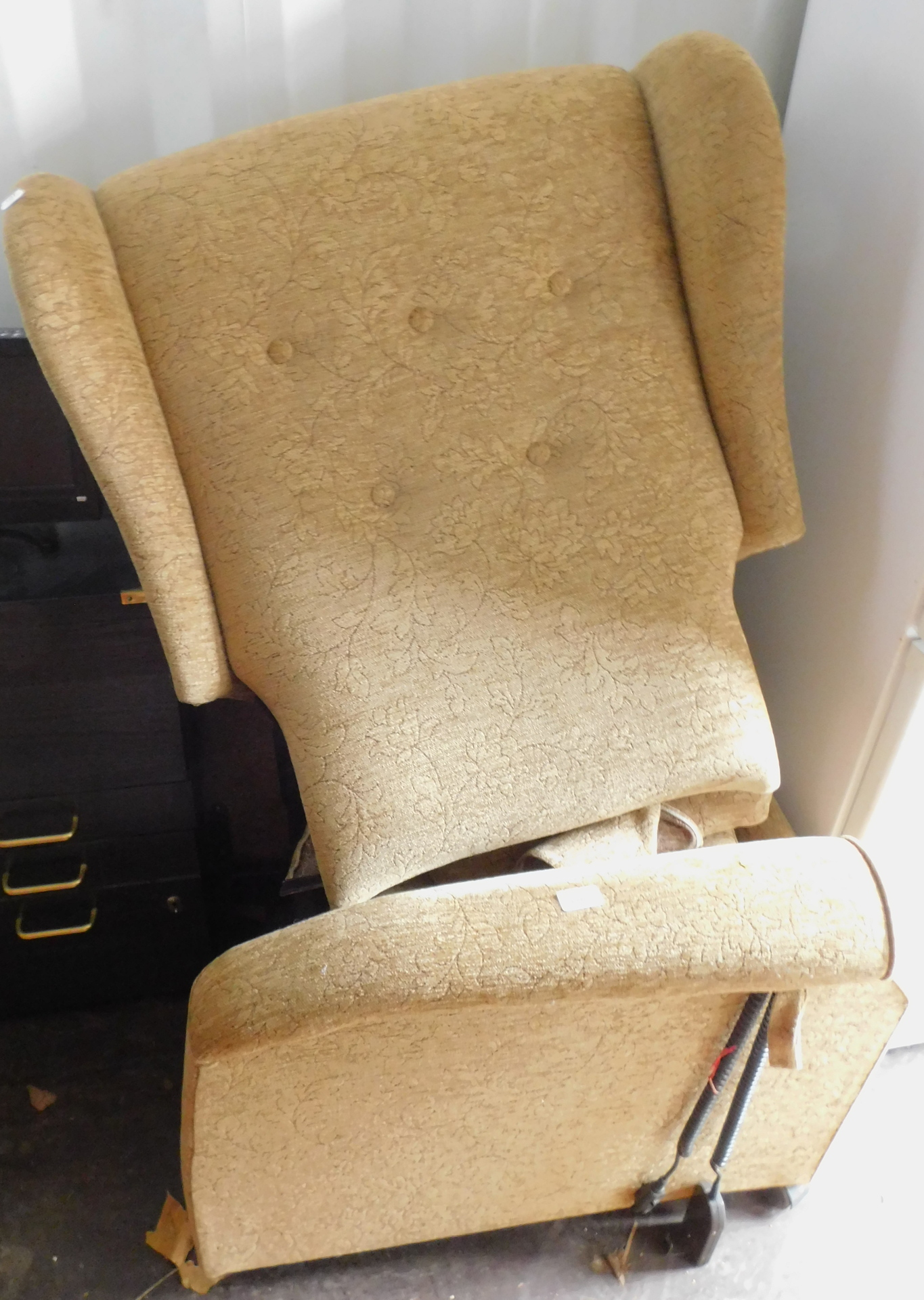 A cream reclining bedroom chair.