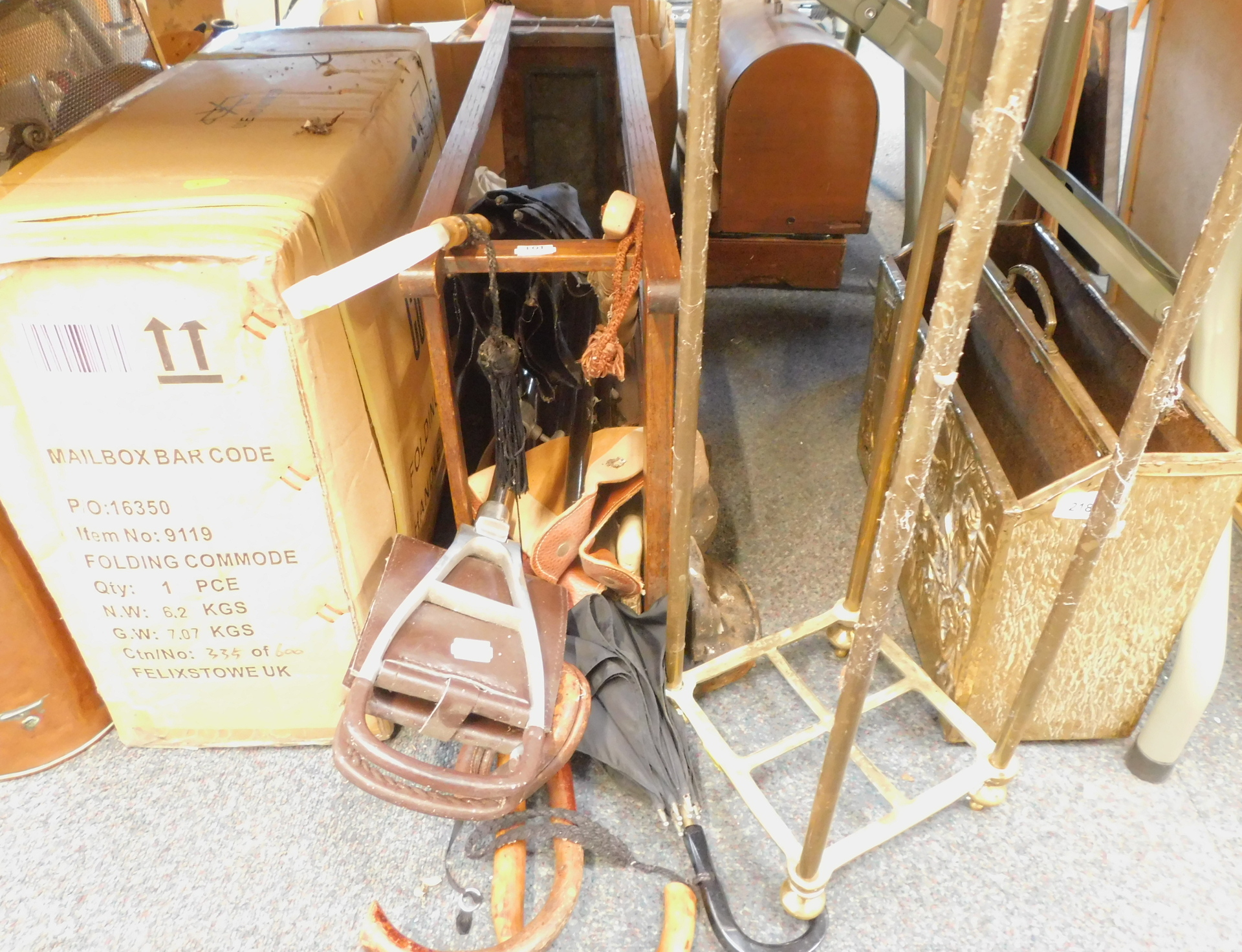 A brass magazine rack, brass plant stand, wooden umbrella stand and various umbrellas and walking st