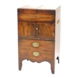 A George III mahogany bedside commode, the hinged lid raised above a cabinet and two drawers, on sha
