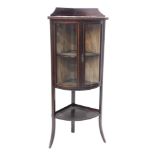 An Edwardian mahogany and chequer banded standing bow fronted corner display cabinet, with a raised