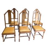 A set of 6 oak high back dining chairs, each with Tudor rose splats, with drop in seats on turned fr
