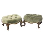 A pair of Victorian walnut footstools, each with a green fabric buttoned top, on cabriole legs.