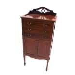 An Edwardian mahogany music cabinet, with three part galleried back raised above three drawers and d