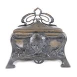 An Art Nouveau pewter finish casket, raised with masks and scrolls, with an elaborate flower head ha