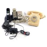 An ivory coloured plastic telephone, with front plastic articulated dial and cord attached receiver,