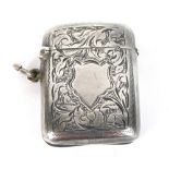 An Edward VII silver Vesta case, with vacant cartouche, decorated with scrolls and leaves, with matc