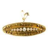 A 15ct gold ellipse brooch, centred with graduated seed pearls, with a plain pin back, 4cm long, 4.9