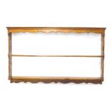 A late 19th/early 20thC oak hanging plate rack, with two shelves, on shaped end supports, 78cm high,