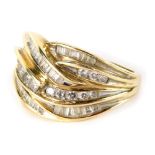 A dress ring, with a swirl arrangement of small white baguette cut stones, with plain shank, marked