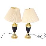 A pair of brass table lamps, each with urn stems, on stepped feet, with modern electrical fittings a