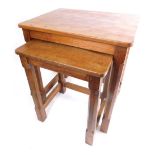 A nest of two 20thC Robert Thompson of Kilburn Mouseman tables, each with adzed tops, on chamfered l