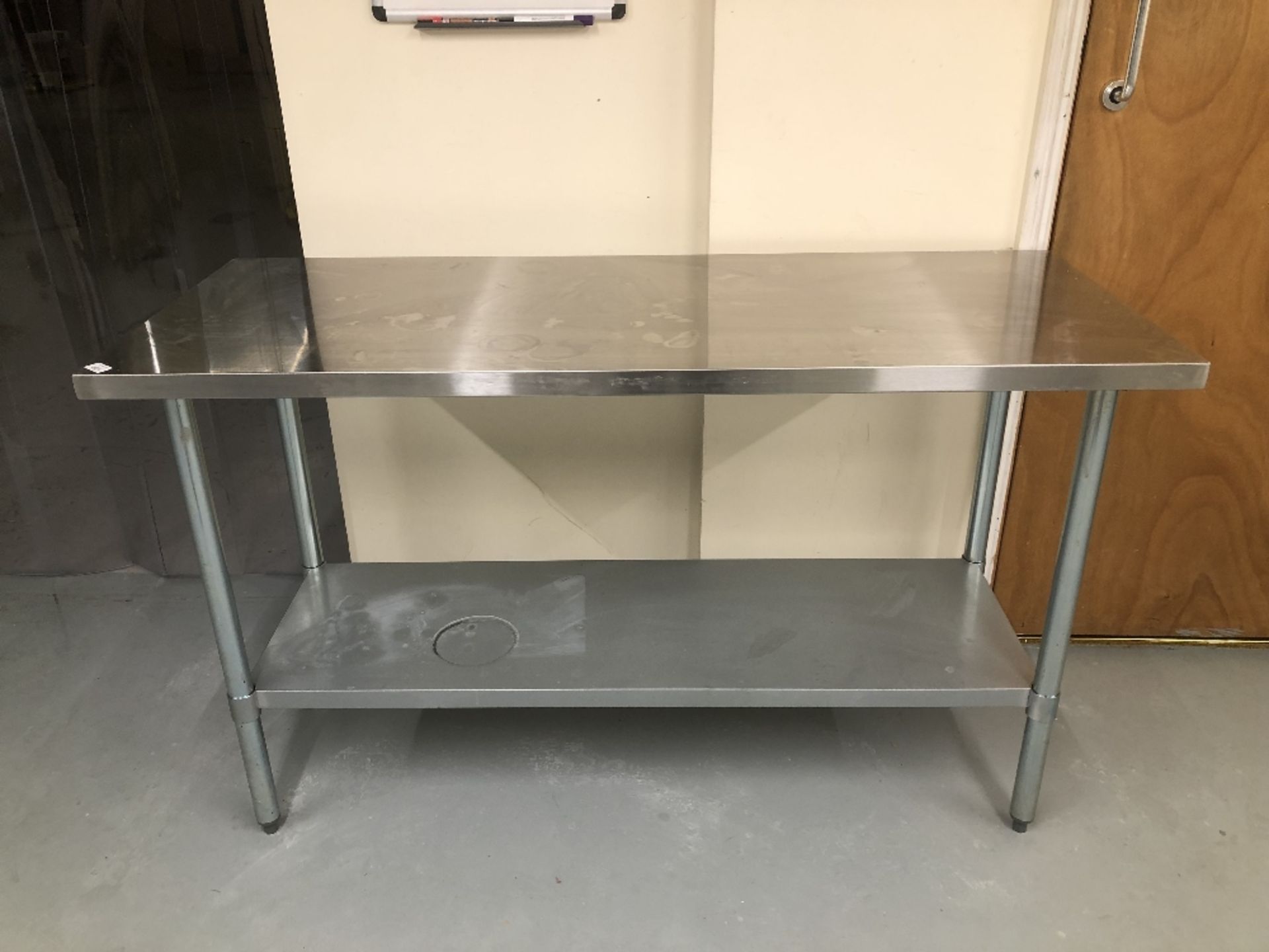 A stainless steel preparation table, 150cm x 60cm. Note: VAT is payable on the hammer price of this