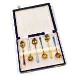 A set of six silver gilt coffee spoons, each with a different coloured guilloche enamel handle, mark