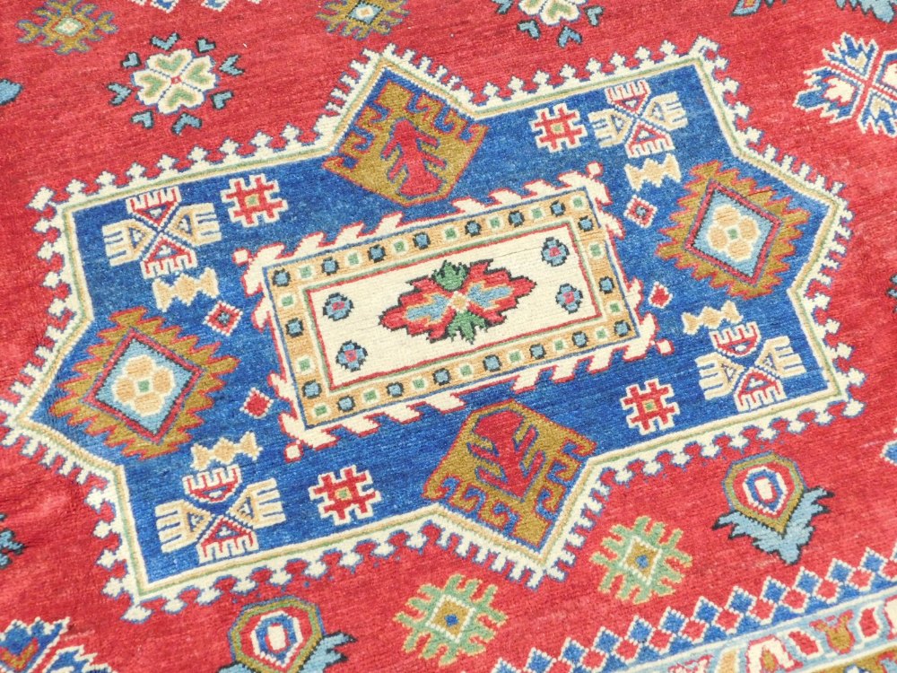 An Afghan Yashak Kajak rug, red ground, decorated with three central medallions and geometric motifs - Image 2 of 3