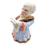 A late 19thC Continental porcelain tobacco jar, modelled as a man seated wearing a smoking jacket an