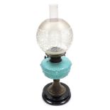 A late 19thC oil lamp, with a clear and etched glass globular shade, with a blue vaseline glass cent