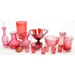 A group of 19thC and later cranberry coloured glass, to include a twin handled vase with a waved rim