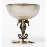 An Elizabeth II silver cup, the bowl of circular form, raised on three conjoined seahorse shaped sup