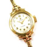 A Cyma 9ct gold cased lady's wristwatch, circular silver dial bearing Arabic numerals, on a 9ct gold