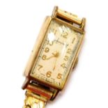 An Accurist 9ct gold cased lady's wristwatch, rectangular champagne dial bearing Arabic numerals, on