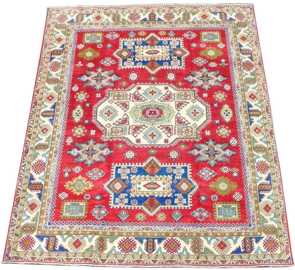 An Afghan Yashak Kajak rug, red ground, decorated with three central medallions and geometric motifs