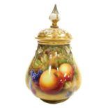 A Royal Worcester porcelain vase and pierced cover, circa 1951, the body painted with fruit, signed