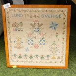 A mid 20thC Swedish woolwork sampler, initialled EL and dated 1944-1954, 35cm x 31cm.