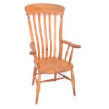 A Victorian oak and elm lath back kitchen chair, raised on turned legs, united by an H frame stretch