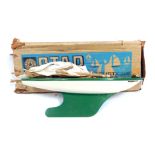 A Star Productions model pond yacht, with a cream hull with green and yellow design, 40cm wide, with