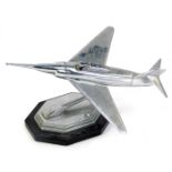 An Art Deco style chrome aeroplane modelled cigarette lighter, on a shaped and ebonised base, 17cm h