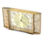 A Metamec 1950s/60s mantel clock, with a central eye design dial, with baton dial, with a mother of
