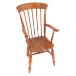 A Victorian oak and elm lath back kitchen chair, with solid saddle seat, raised on turned legs unite