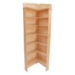 A pine corner bookshelf, with arrangement of six shelves, 192cm high, 56cm deep.